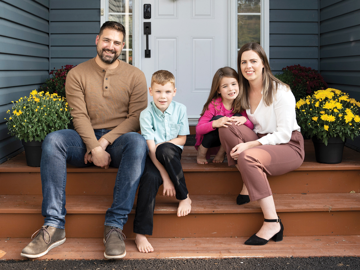 Charlene MacLeod, CPA and her family sitting on their front step 